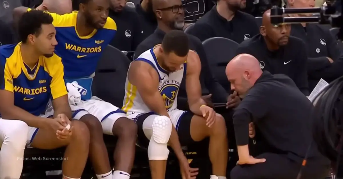 Stephen Curry con el trainer del equipo de Golden State